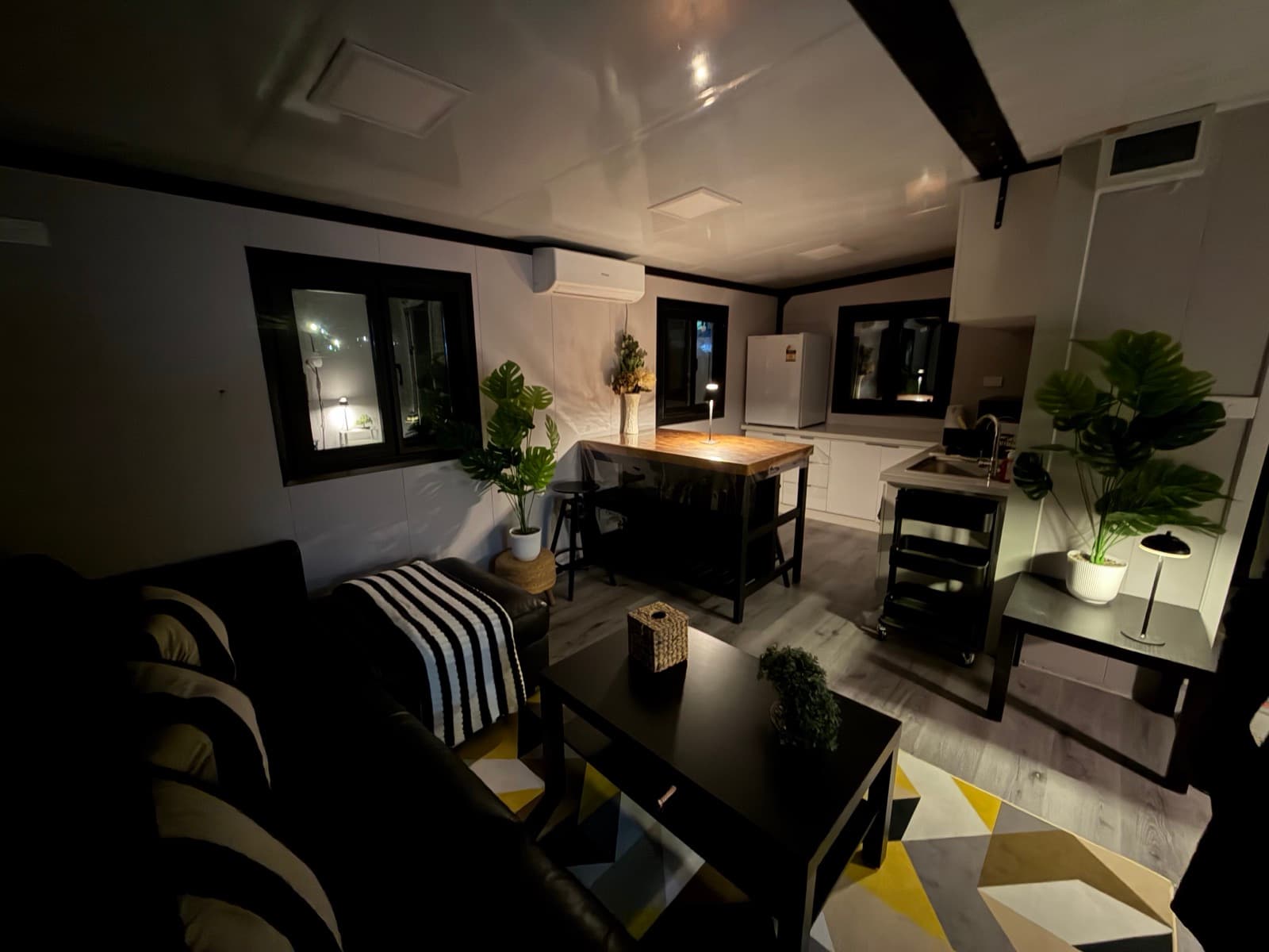 Faith's Escape living area at night with warm lamp light