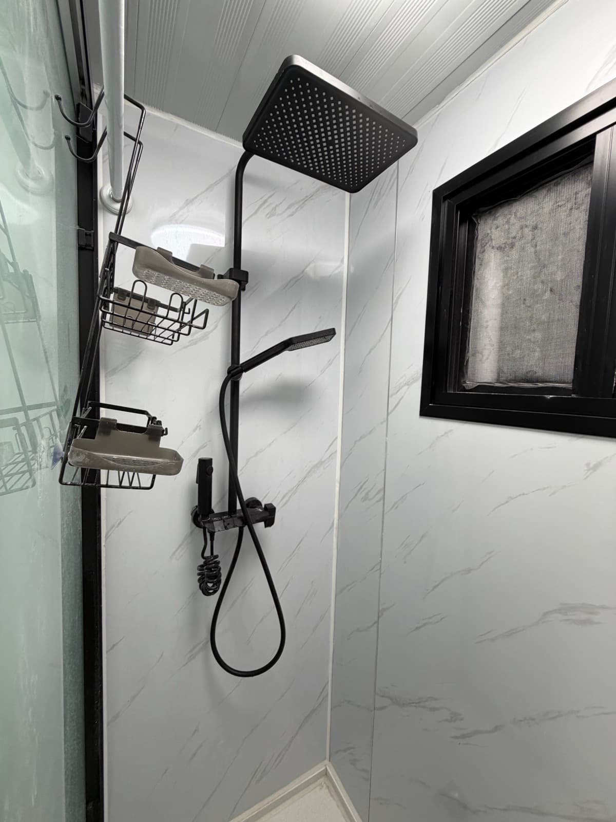 Walk-in shower with rainfall shower head